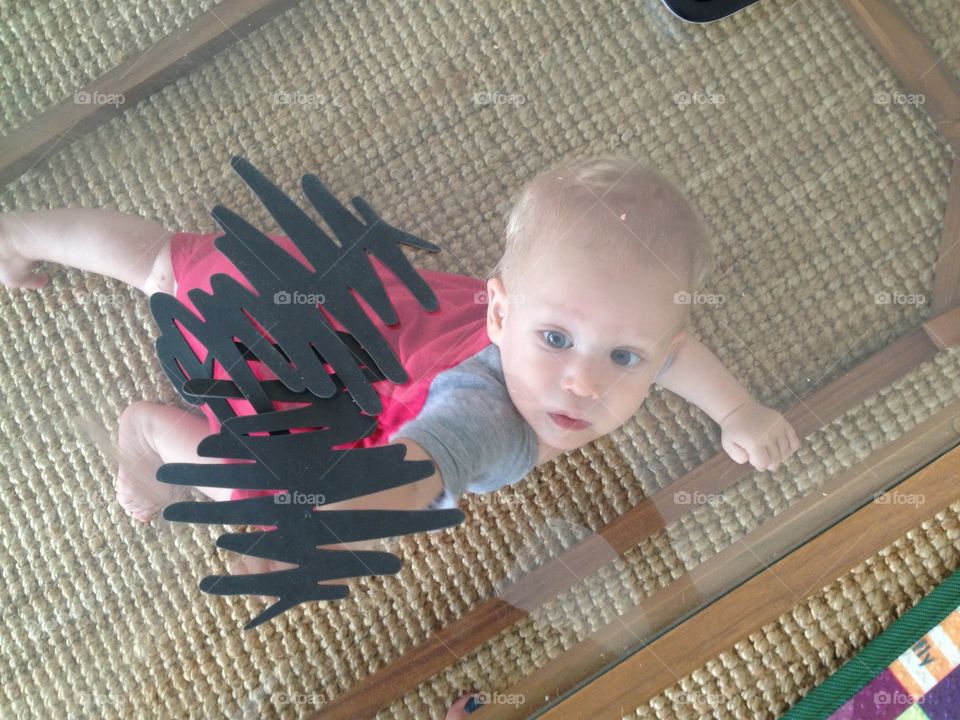 Baby looking through a glass