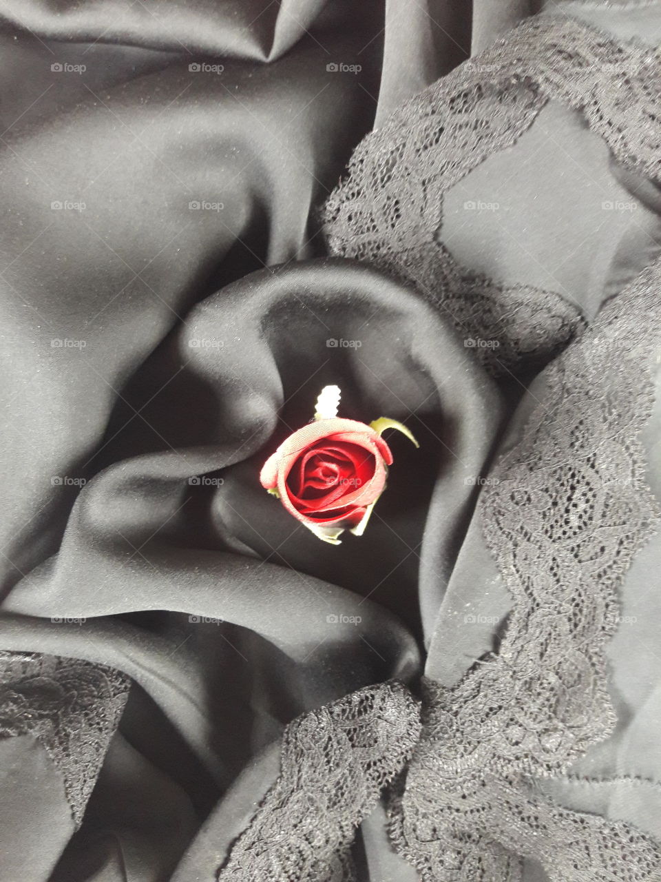 Artificial rose flower on textile