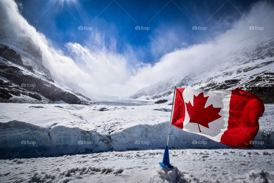 Canada flag on snowy mountains