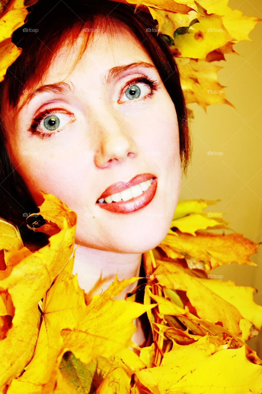 Autumn portrait of a woman in golden leaves