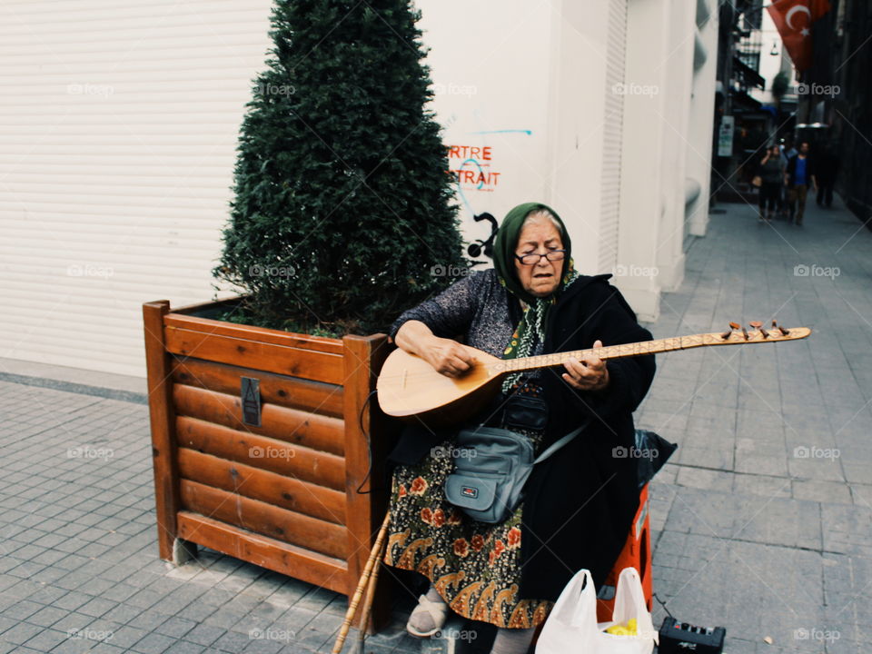 Elderly Lady Making Music