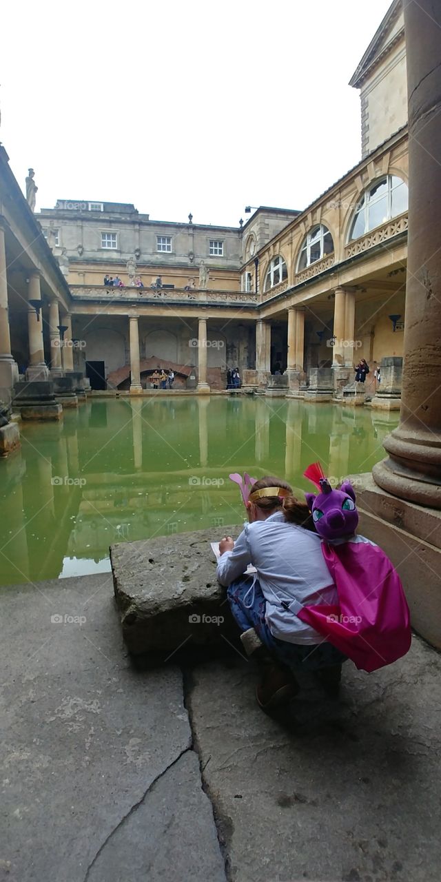 girl studying on edge of historic building