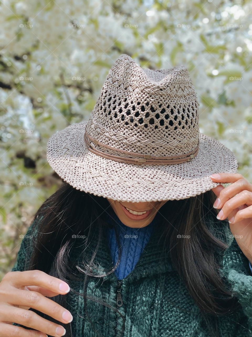 A woman holding a gray hat