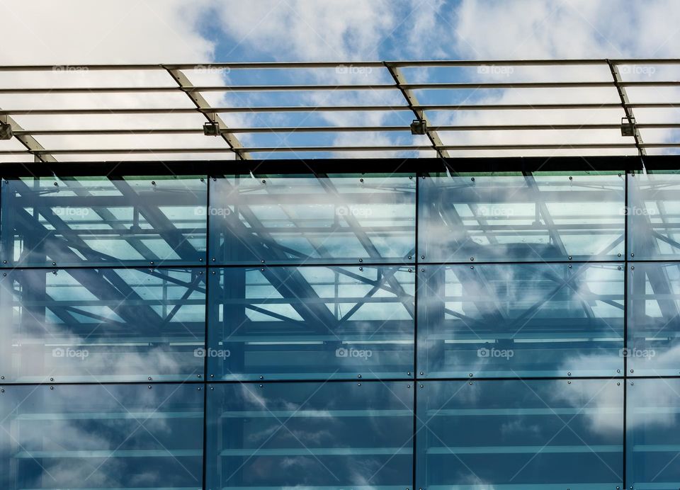 A section of the roof of Brighton Library, with clouds.