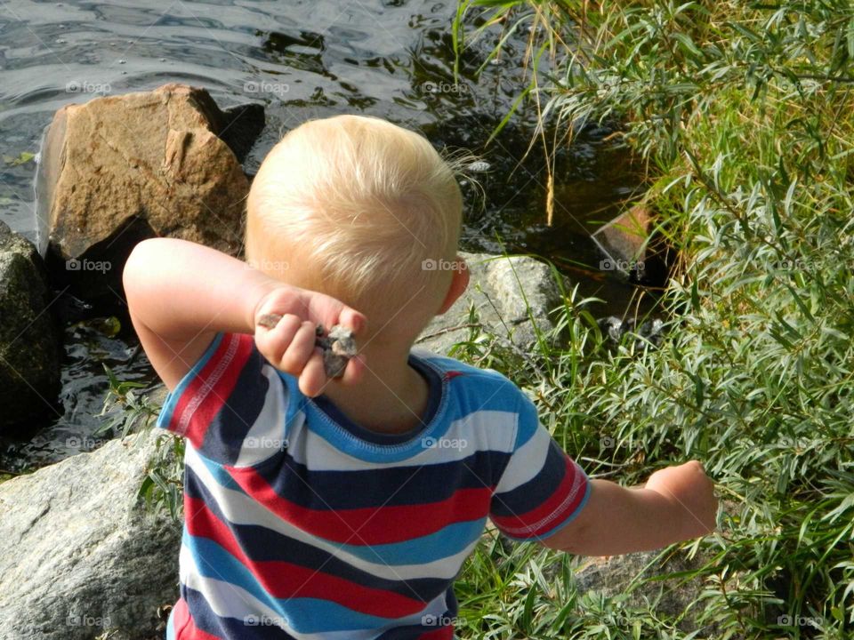 Boy throwing rocks