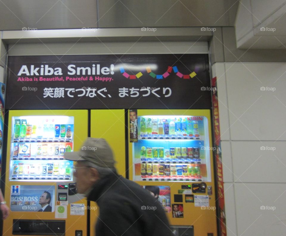 Colorful, Modern Akiba Smile Vending Machine in Akihabara, Tokyo, Japan. Elderly Man Walking Past.