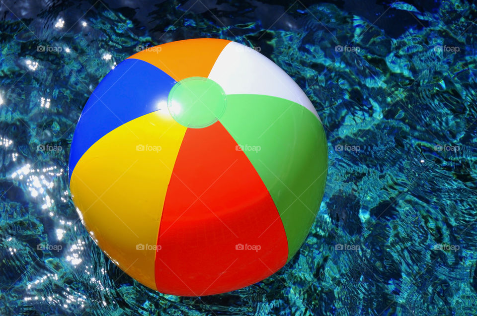 Beach ball. Colorful beach ball floating in swimming pool