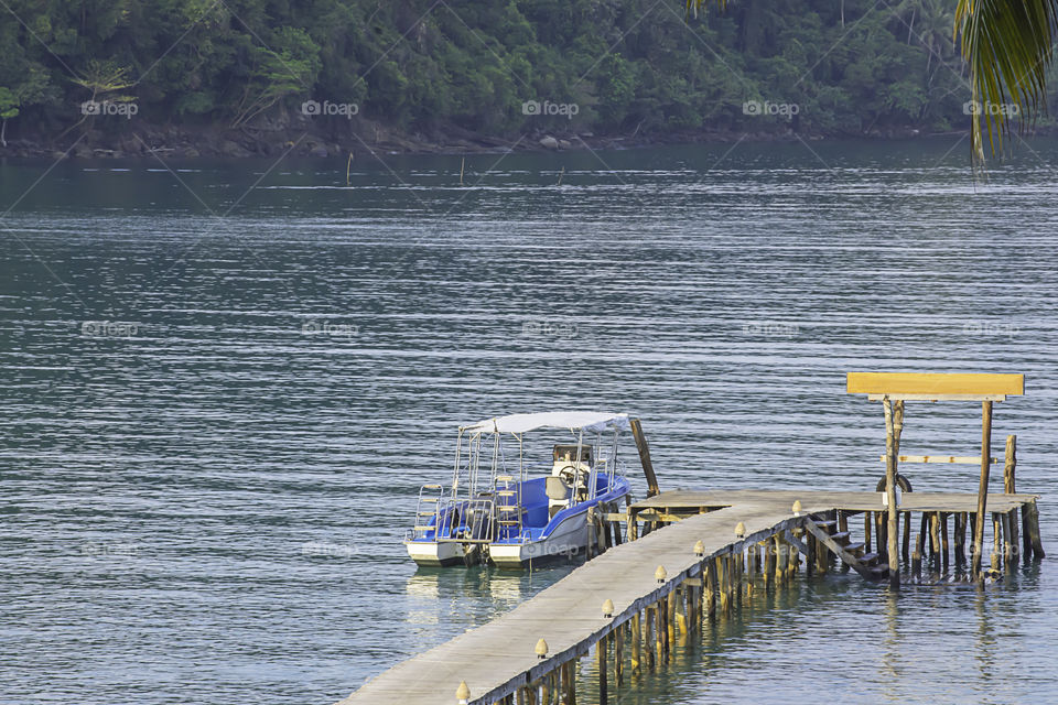 Speed boats moored at the wooden bridge In the summer sea at Koh Kood, Trat in Thailand.