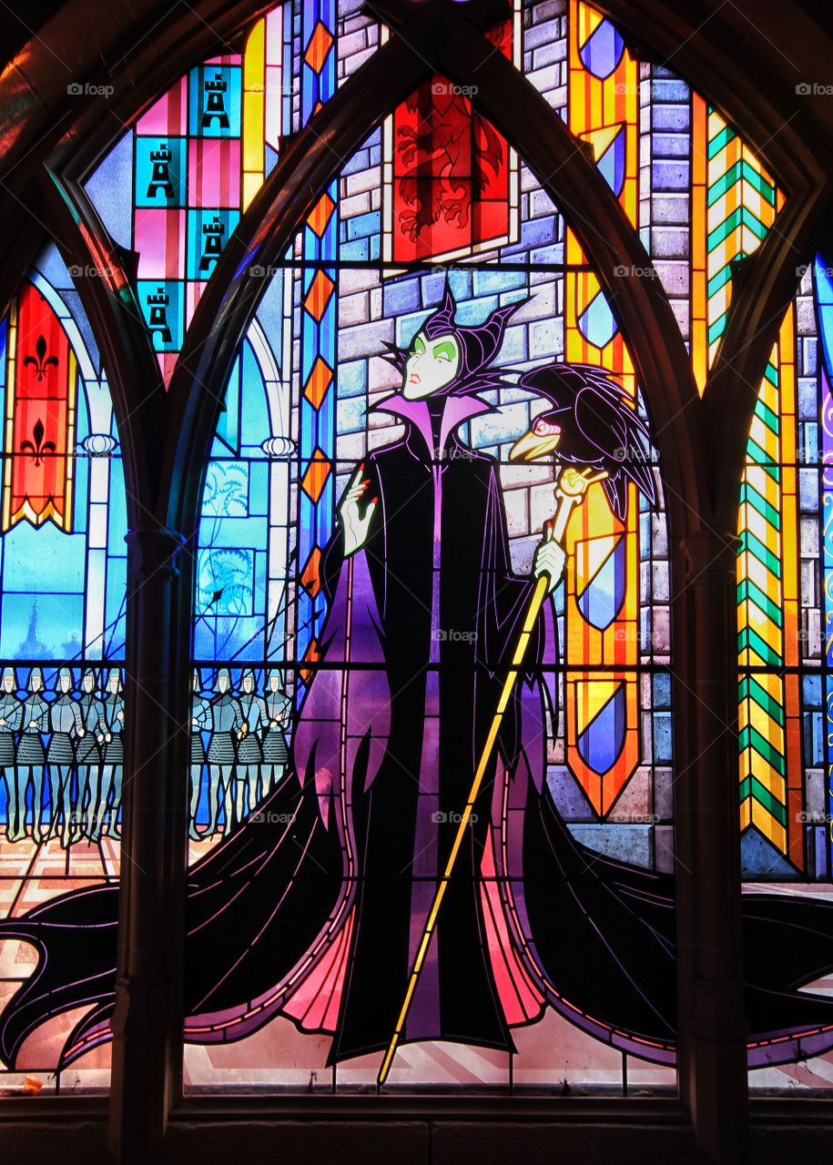 Disney's Maleficent Window. A colourful stained glass window depicting Disney's Maleficent in Disneyland.
