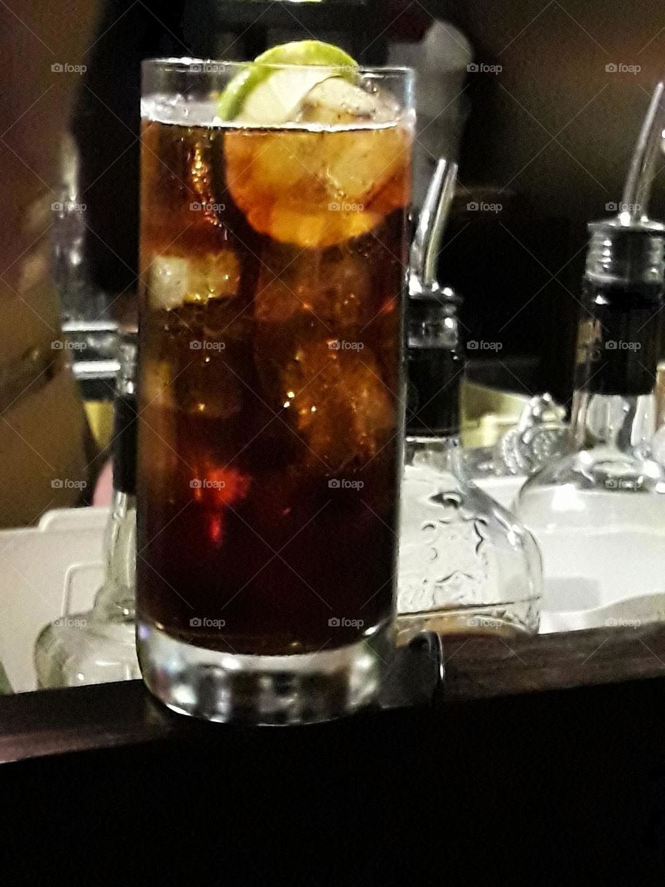 A cocktail with cola, tonic water and lemon