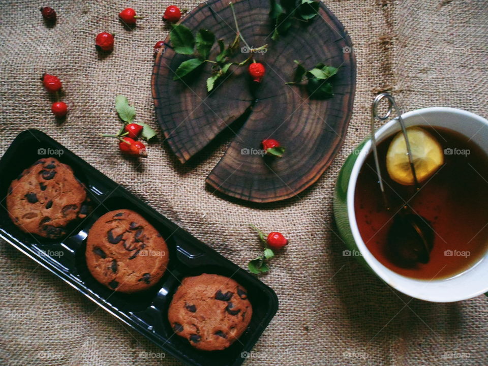 oatmeal cookies with chunks of chocolate and a cup of tea, dessert