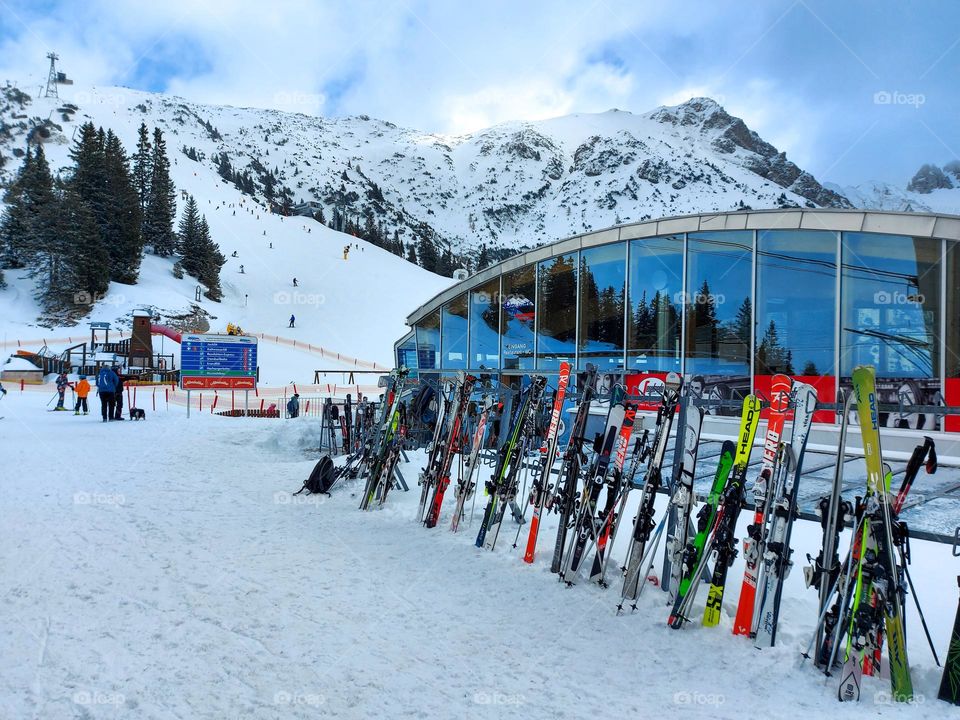 ski slope and many skis in front of a restaurant