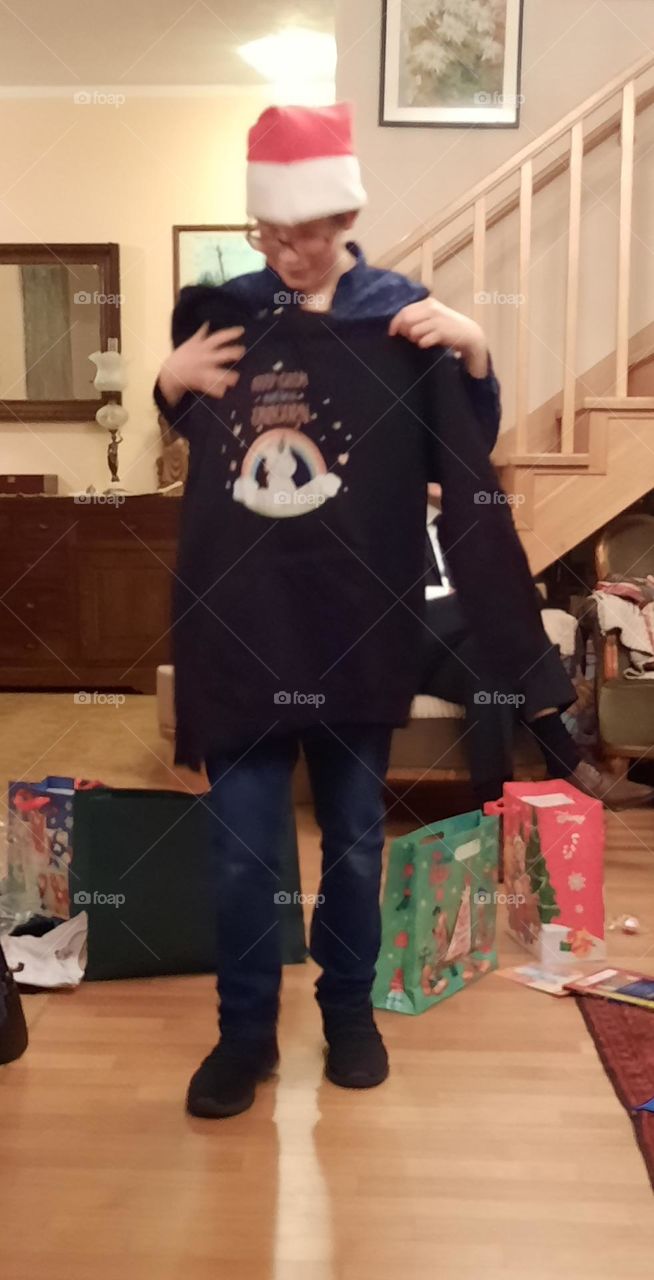 little boy receiving Christmas gifts