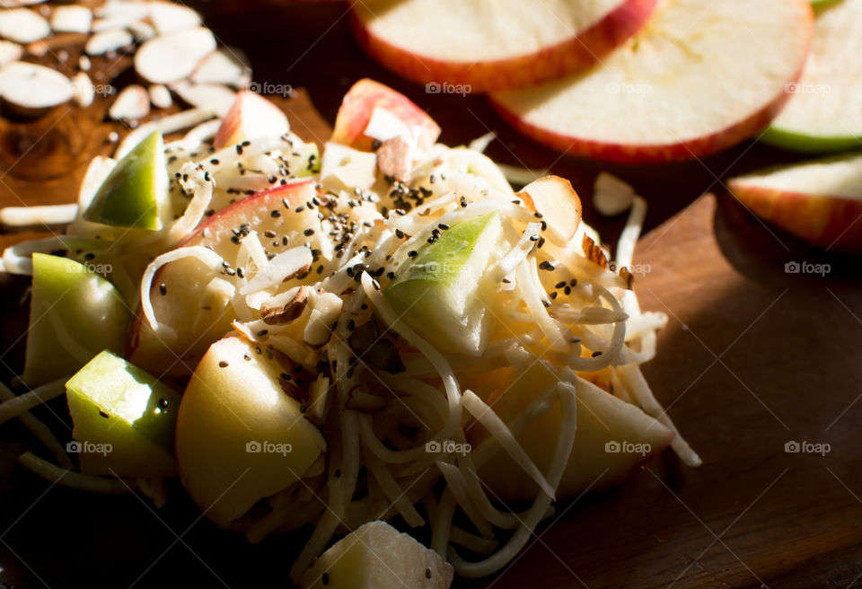 Fresh summer apple and celery root salad with chia seed and Almond nuts healthy refreshing salad rich in nutrients gourmet food photography variation in classic Waldorf salad