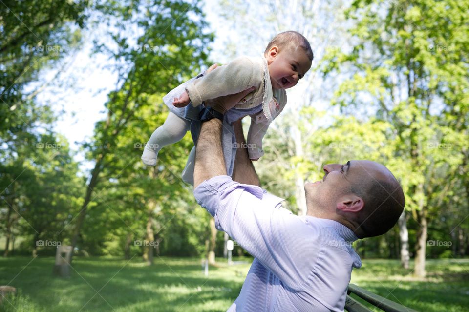 happy little girl in dad's arms