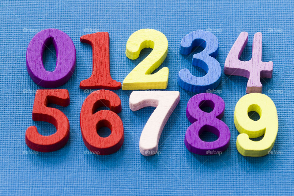 colored wooden numbers,  blue background.  learn happy and brightly !