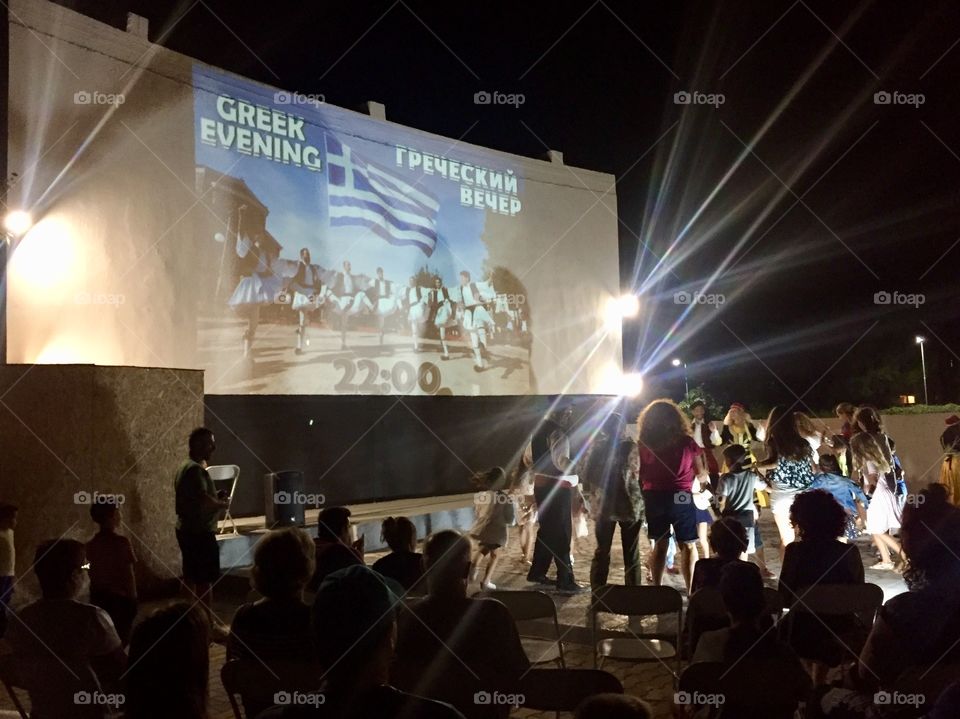 Silhouette of people dancing and enjoying in Greece resort
