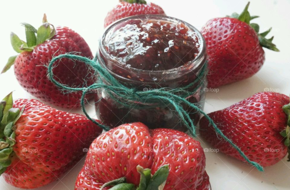 Strawberry jam against white background