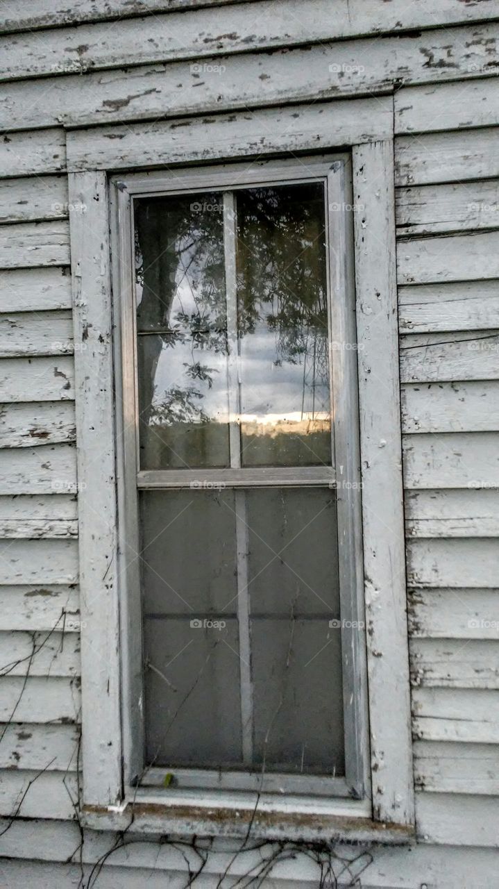 Sunset window in old abandoned house on family farm in rural South Dakota