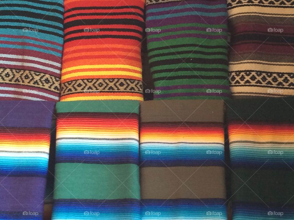 Beautiful and colorful display of striped Native American made blankets 