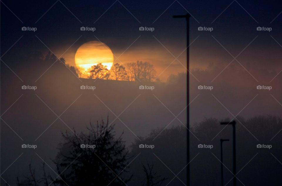 Sun in clouds during sunset