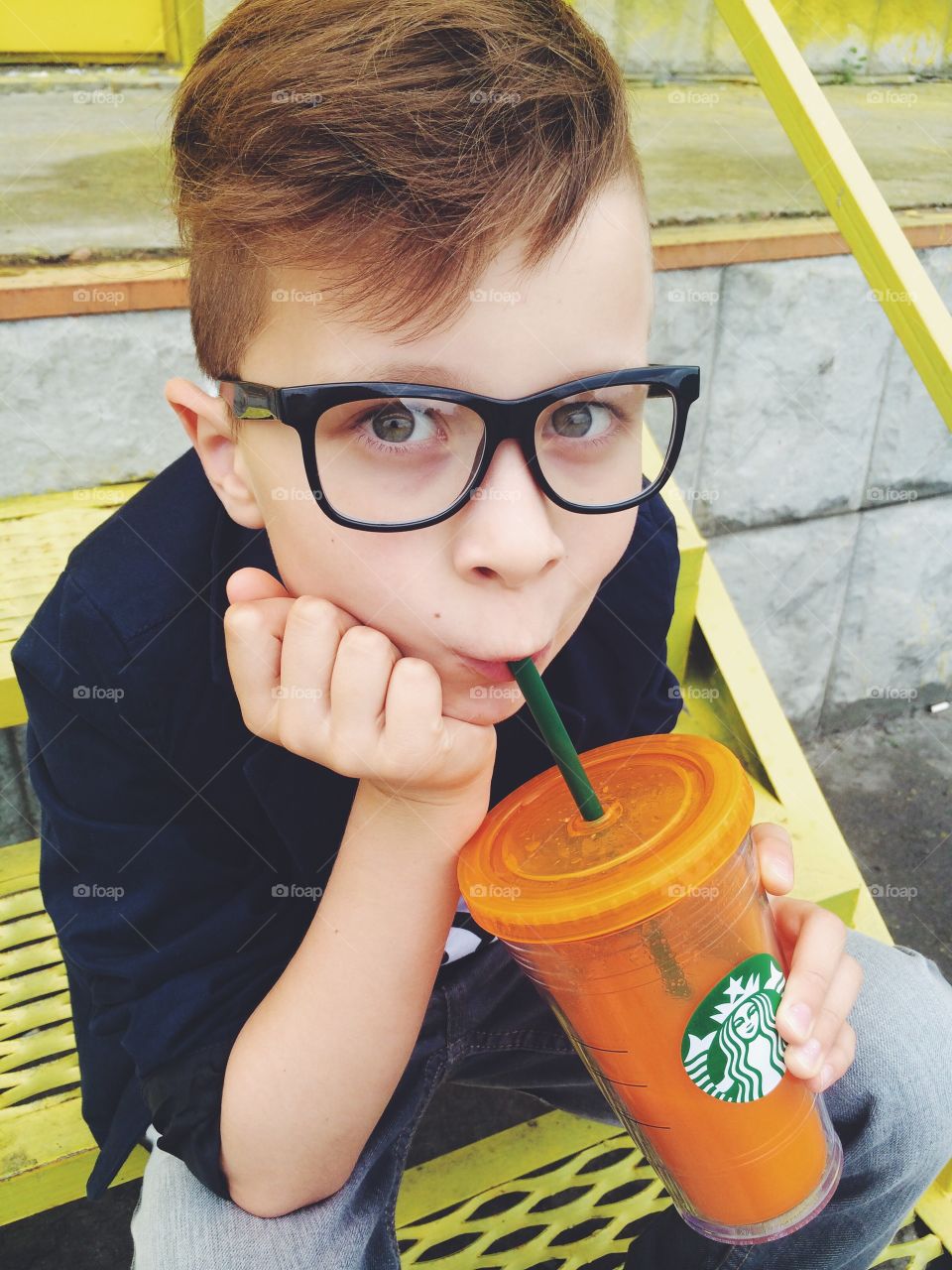 Small boy drinking cold drink