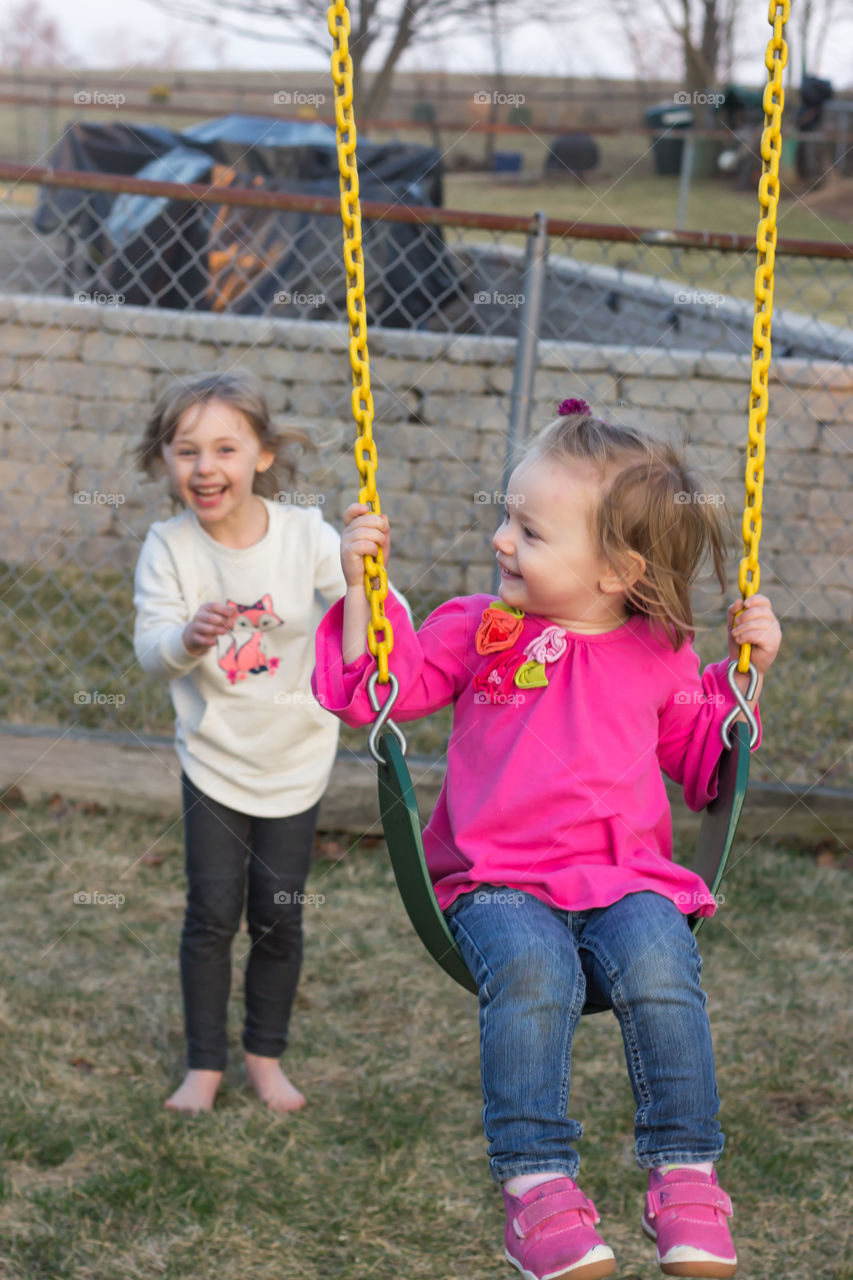 sisters on swingset