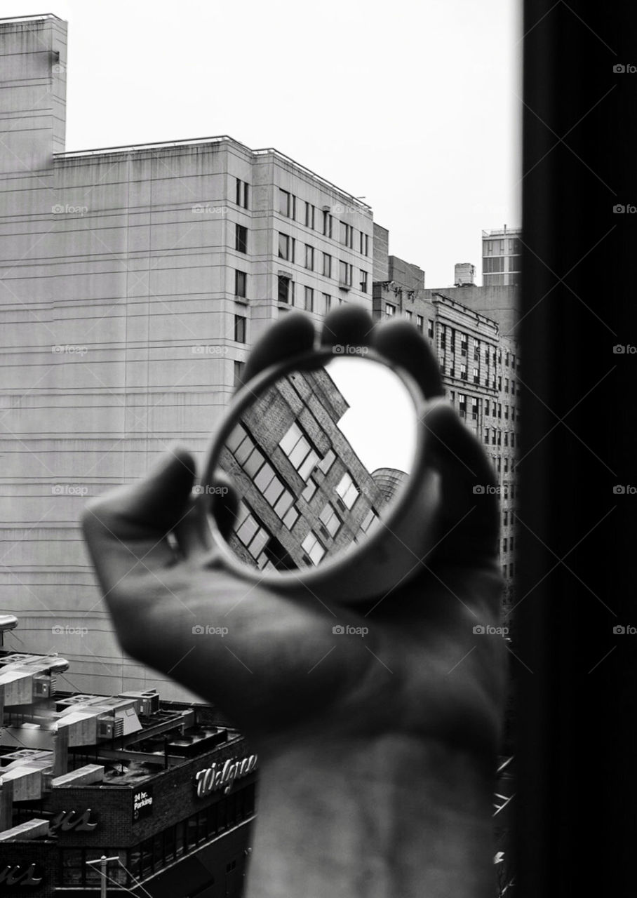 City reflected in a hand mirror 