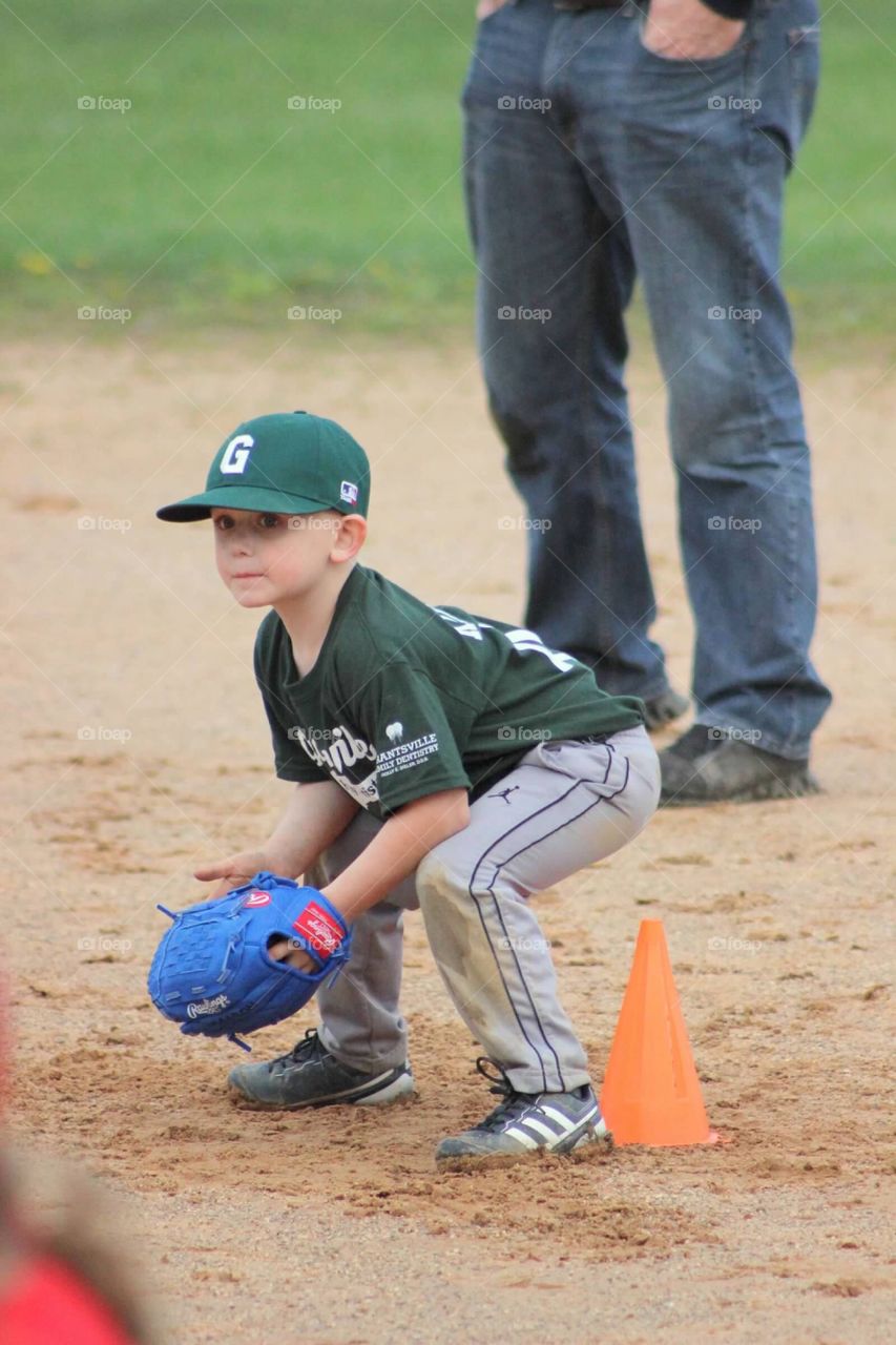 My little baseball player down and ready to field a ground ball at second base. 
