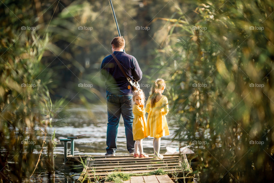 Family fashion on a lake at autumn day