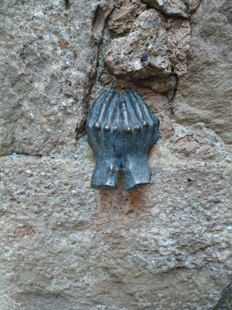 sculpture of hands on the wall