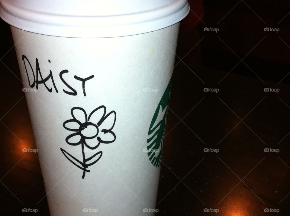 Starbucks cup with daisy drawing