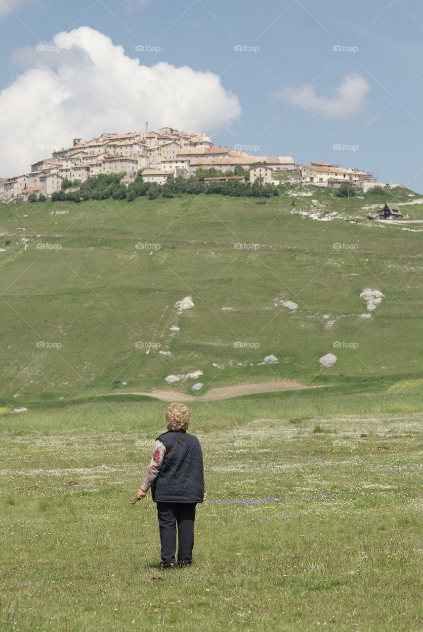 Tourist looking at the village of Castelluccio, Italy