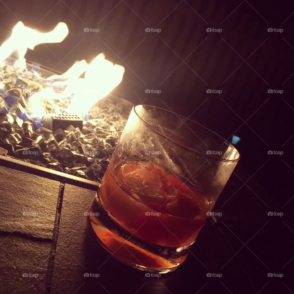 Cocktails by the fire. Bourbon cocktail at night