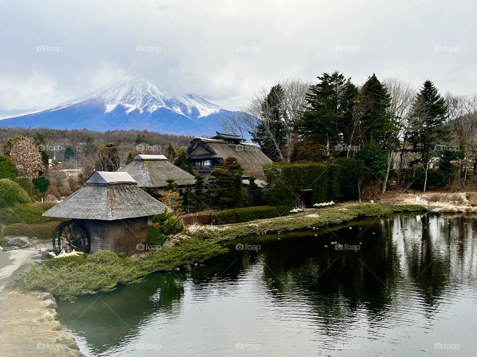 Early spring in Oshino Hakkai Park, an old village in Japan with Mount Fuji as a background