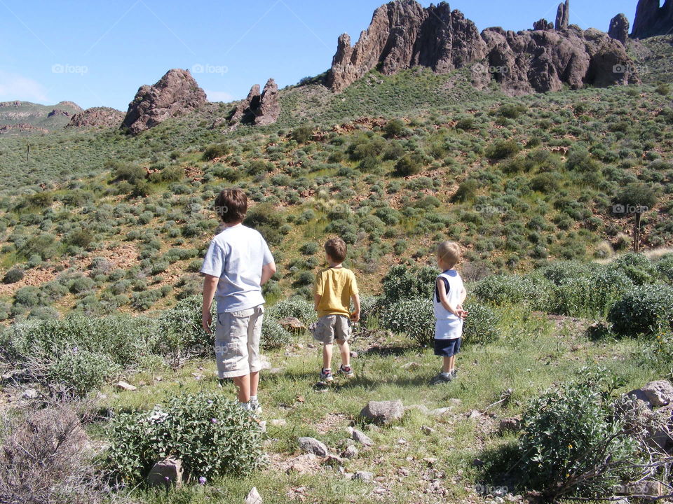These boys are hiking in the mountains of the Arizona desert.