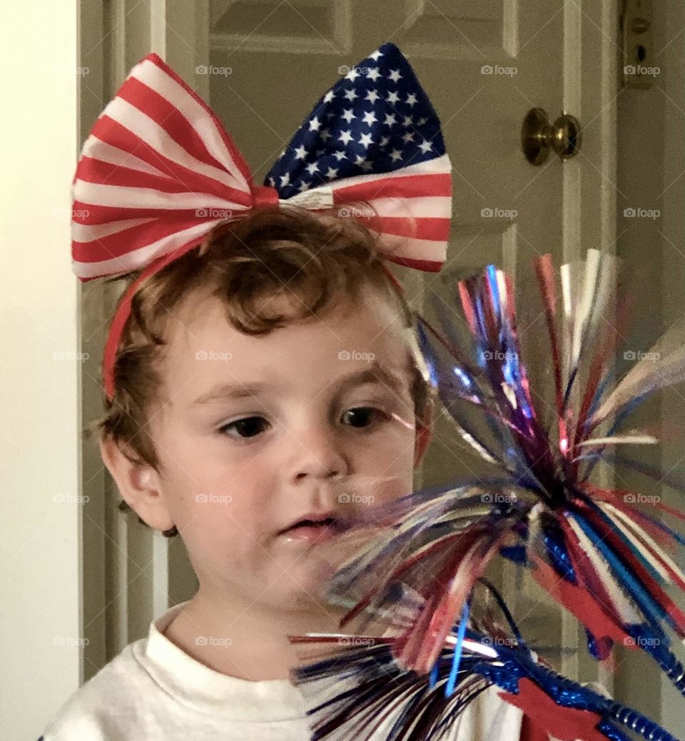 Toddler boy with Stars and Stripes bow and streamer