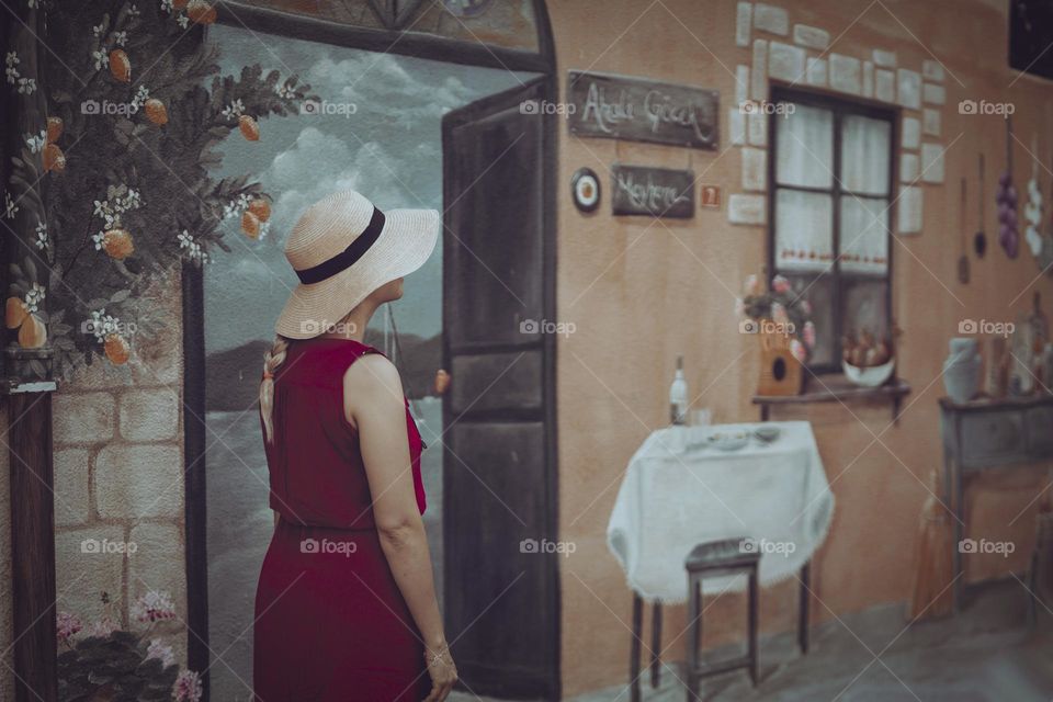 Lady in front of a painted wall