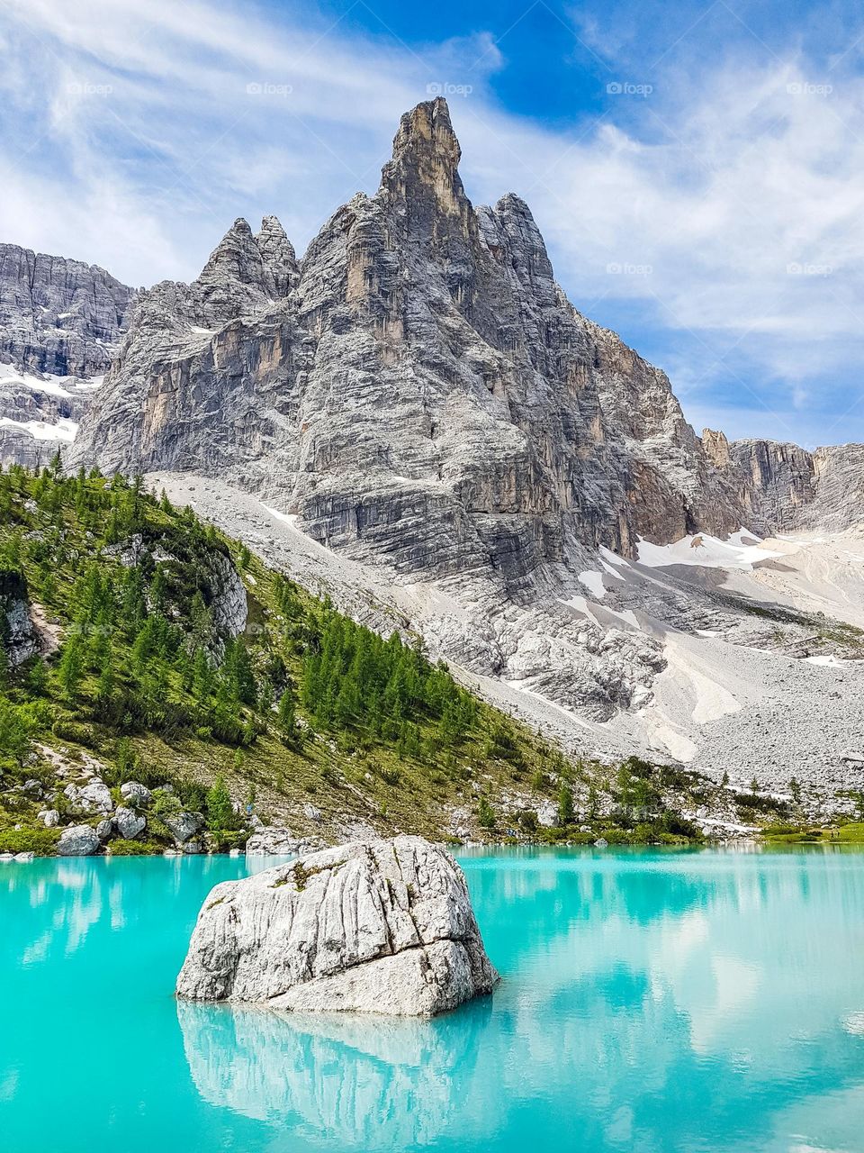 Spectacular landscape featuring turquoise lake under rocky mountains at Lake Sorapis in Italy
