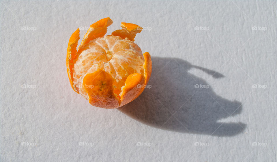 Half-peeled mandarin on a white background