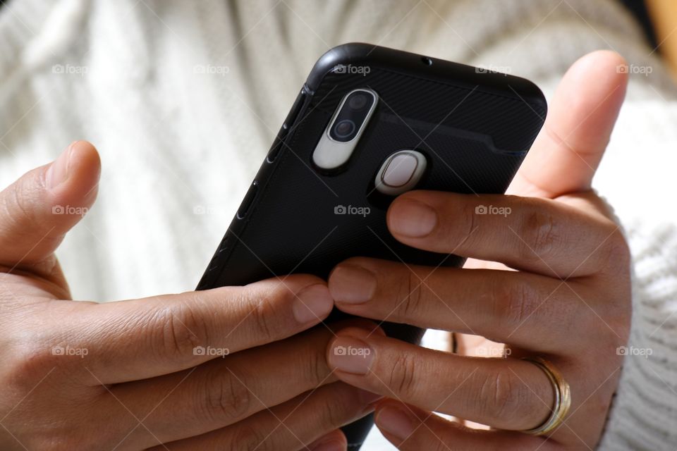 smartphone in hands in close-up