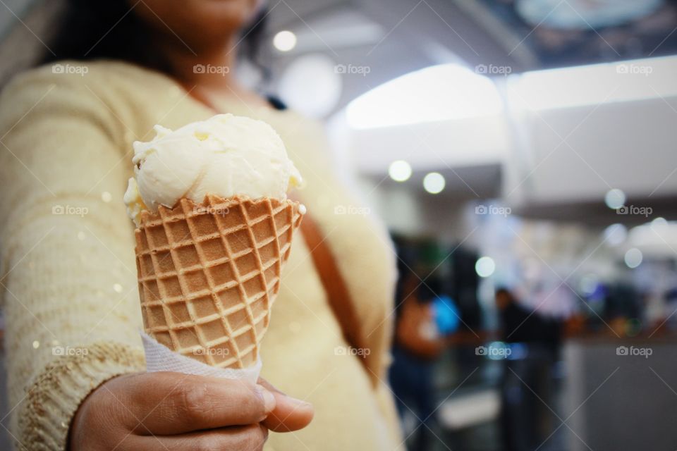 Woman offering ice cream cone
