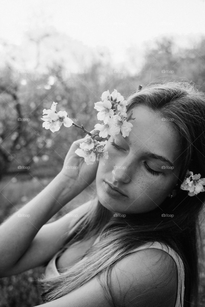 Portrait of beautiful girl with almond flowers