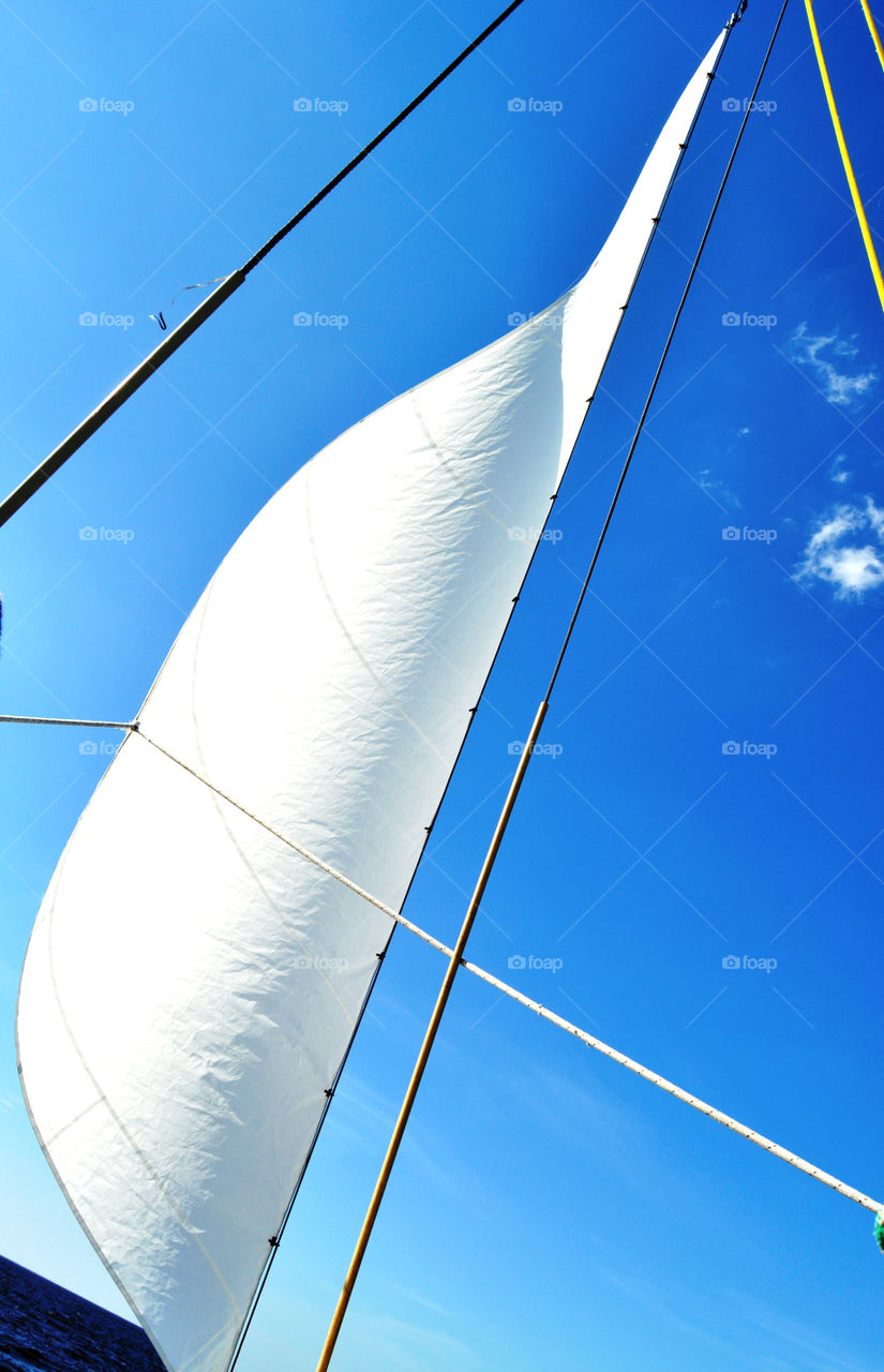 White sail on the blue sky 