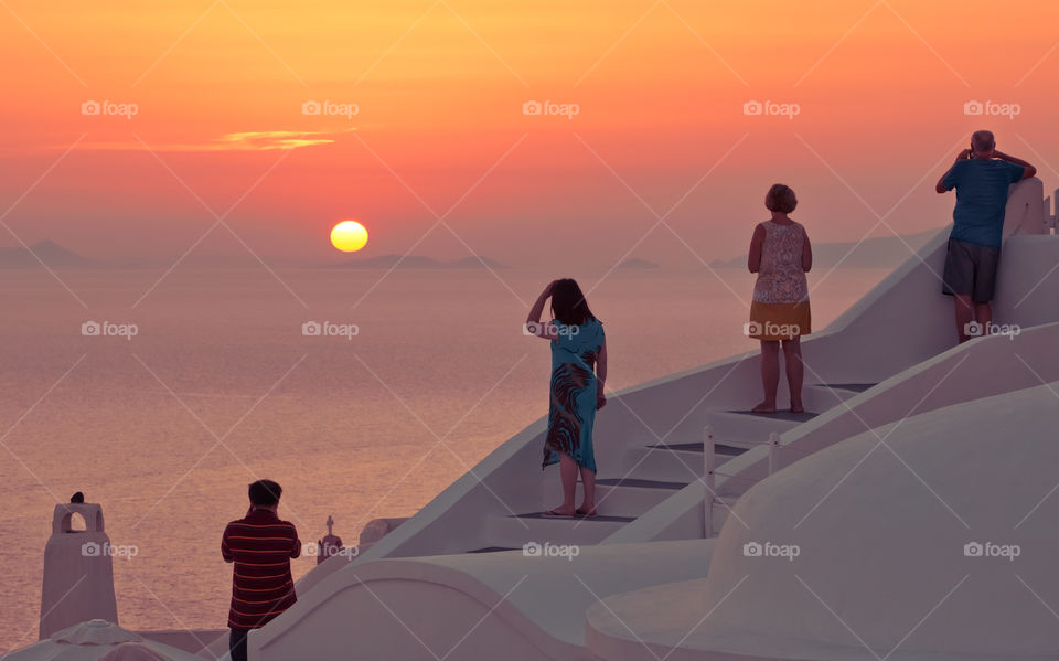 People Enjoying Sunset On Famous Greek Island Santorini