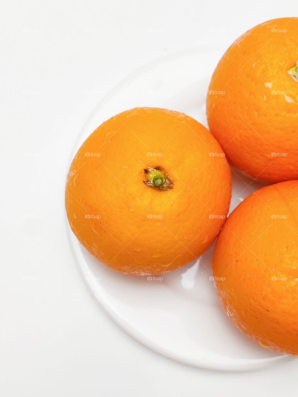 fresh orange on the white plate