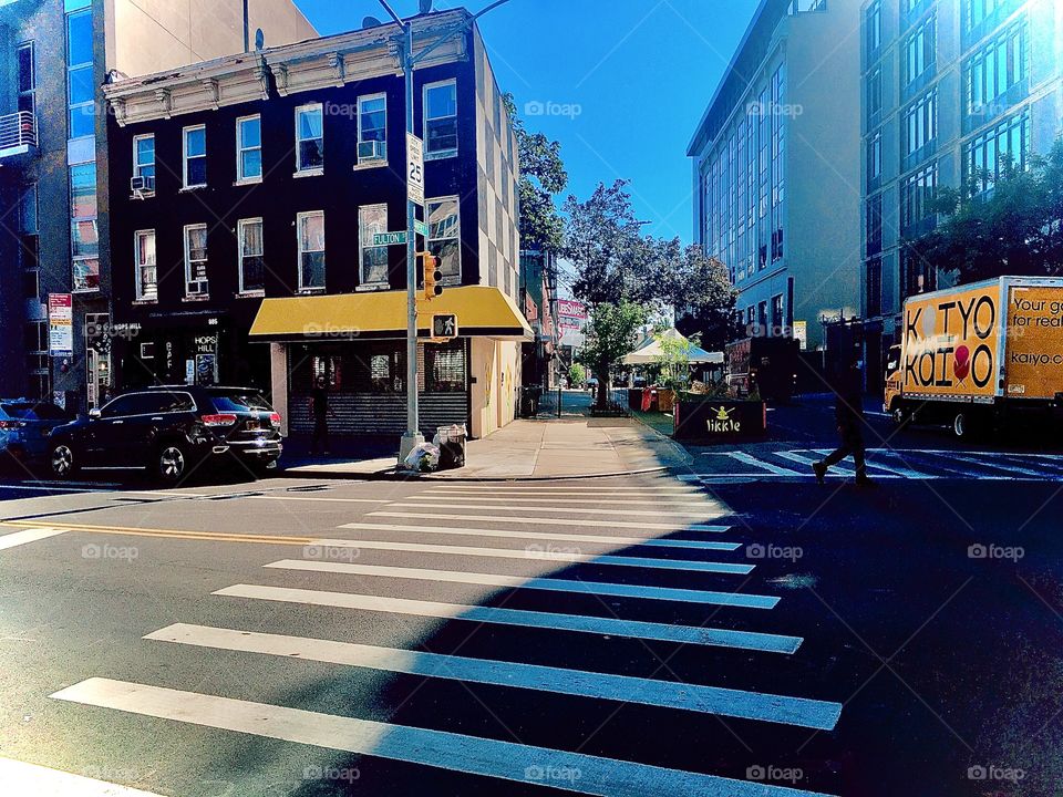Fulton Street in Brooklyn, New York bathed in the late afternoon sunlight during the summer of 2020 which is when this picture was taken.