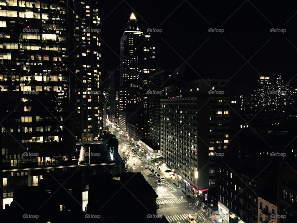 Illuminated building and roads at night in city