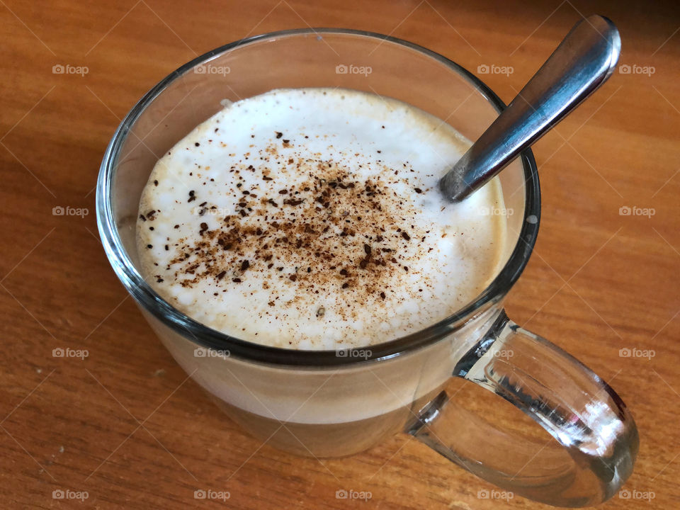 a glass of cappuccino with cinnamon