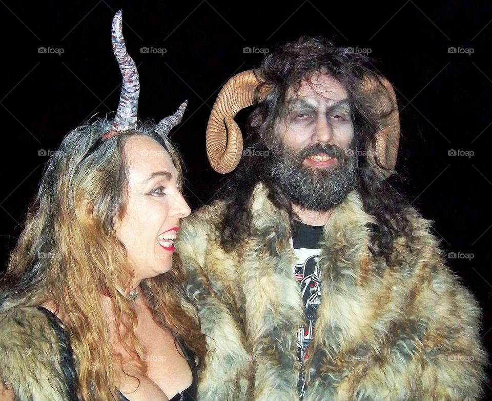 Close-up of a happy couple with horn during halloween